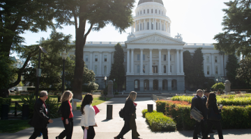 Advocates walk in front of the California capitol in Sacramento