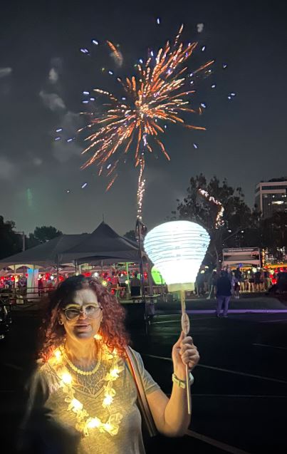 Light The Night event with white lantern and fireworks honoring blood cancer survivor