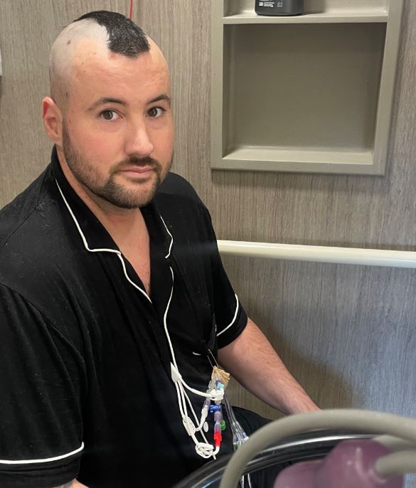 leukemia patient wearing a black shirt in the hospital receiving treatment