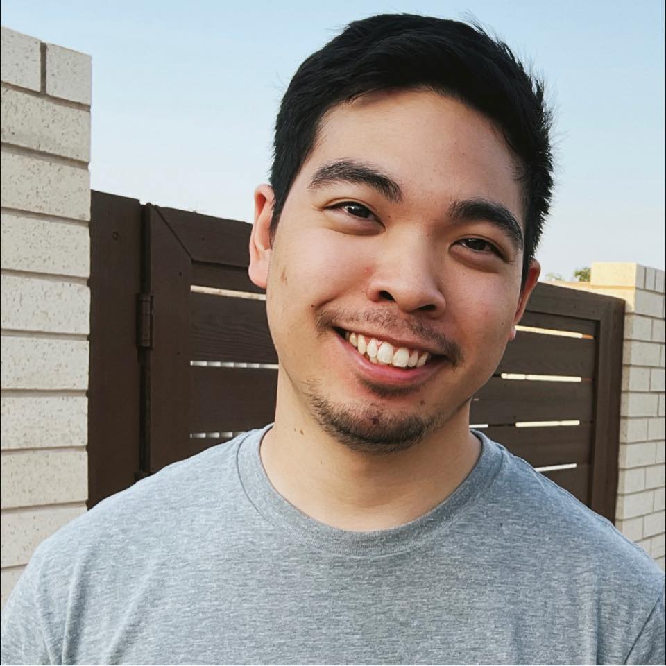 young adult smiling with short dark hair blood cancer survivor