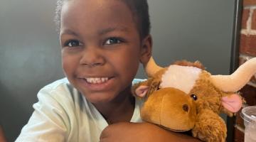 Cayden holds his stuffed animal.