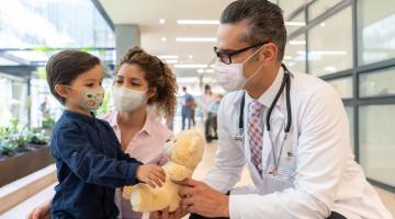 Doctor with pediatric patient and parent