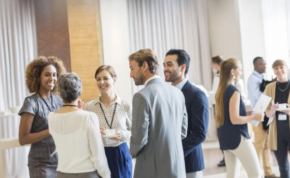 Professionals speaking to eachother at a meeting