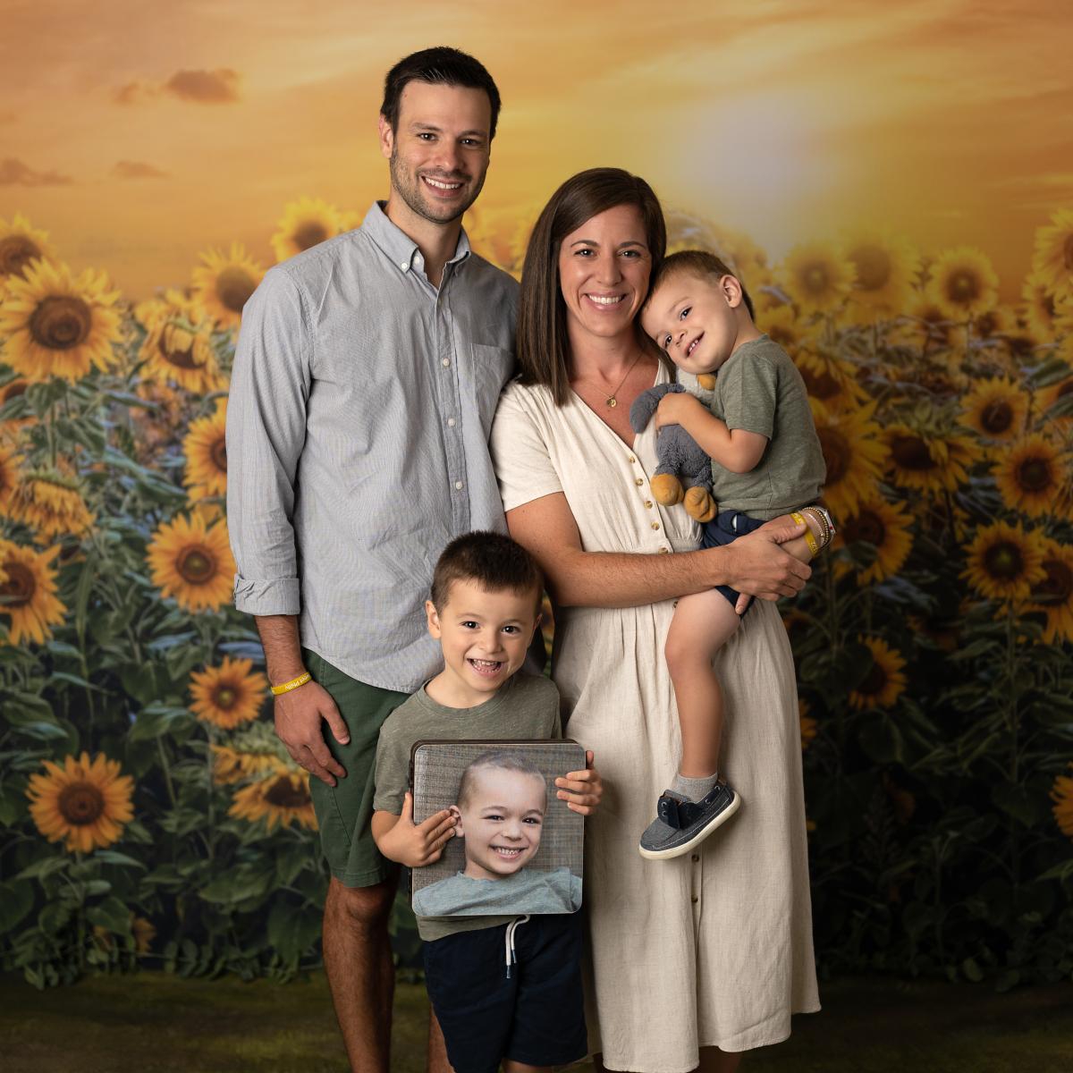 Phil's family holding his photo