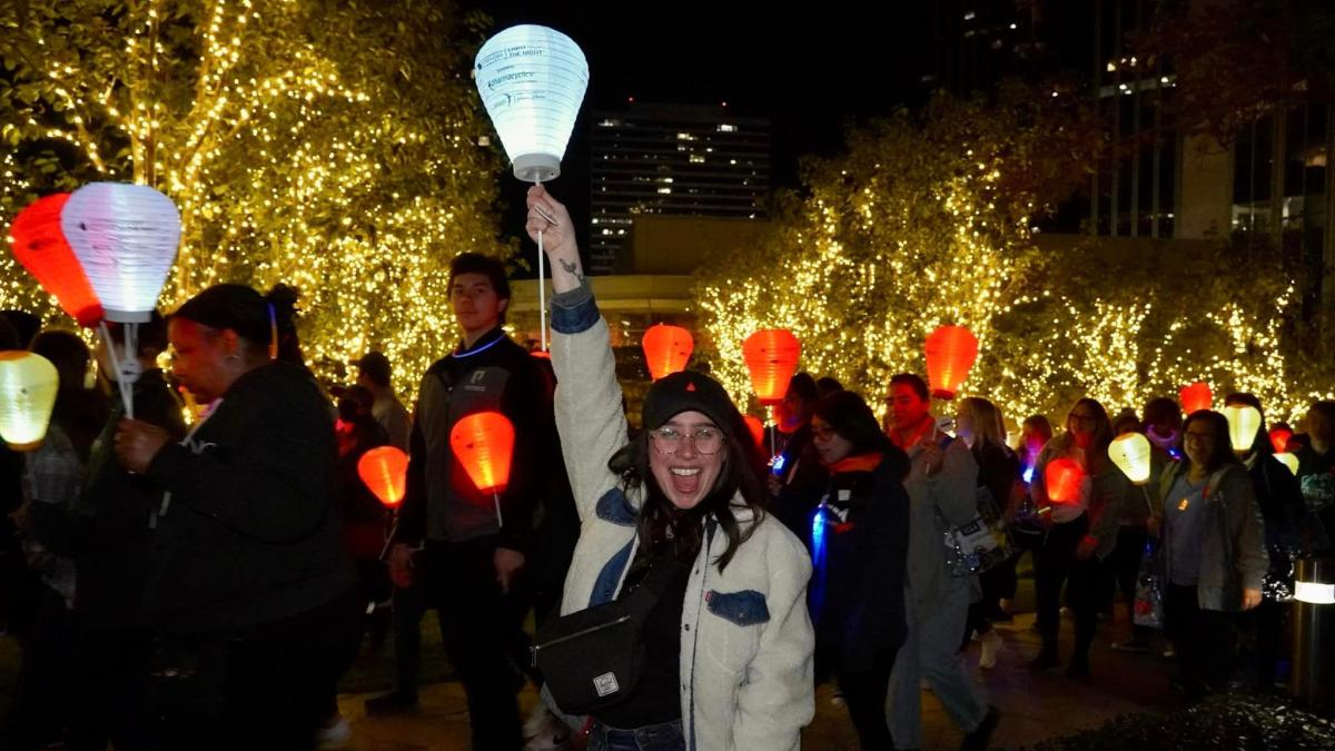 Racheli at Light The Night holding up her white lantern