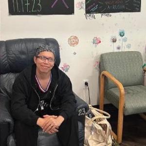 young blood cancer patient sitting in chair