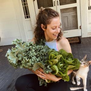 non-Hodgkin lymphoma survivor with green plant and cute cat