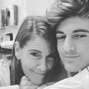 Michael and Ashlee black and white photo of Mom with three earrings in right ear and teenage son with stylish hair in a hospital room