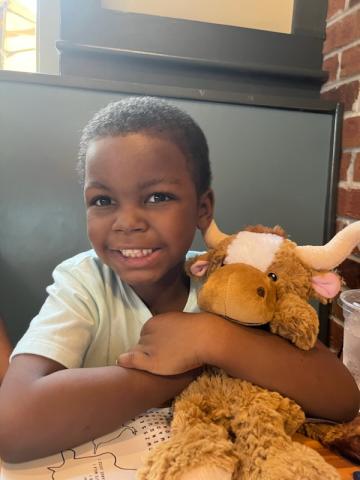 Cayden holds his stuffed animal. 