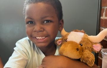 Cayden holds his stuffed animal.