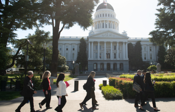 Advocates walk in front of the California capitol in Sacramento