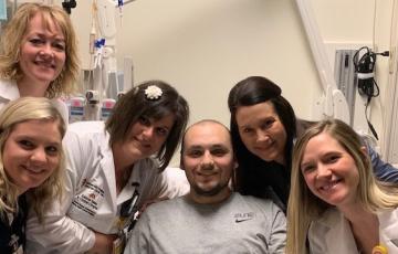 Nurse Sloane and her colleagues posing with a patient